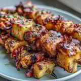 Colorful chicken and pineapple skewers with charred edges and vibrant bell peppers, perfect for summer BBQs.  