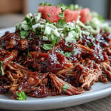 Tender, slow-cooked Juneteenth BBQ Pulled Pork piled high, topped with refreshing watermelon slaw.