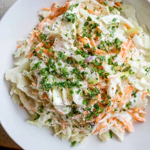 Fresh Coleslaw with Apple, a vibrant, colorful salad with crunchy cabbage and grated apple, ready to serve.