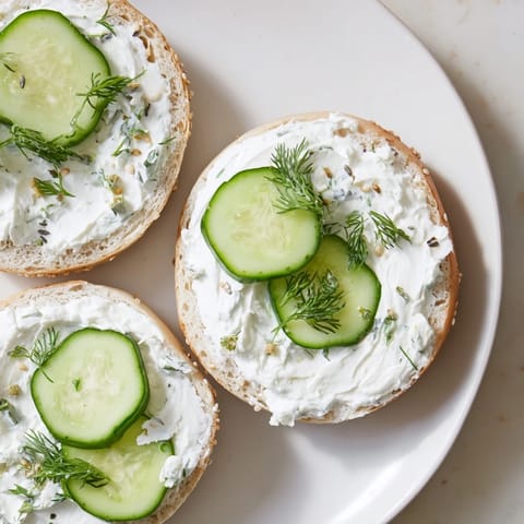A close-up of a perfectly toasted bagel with a creamy spread of cream cheese.