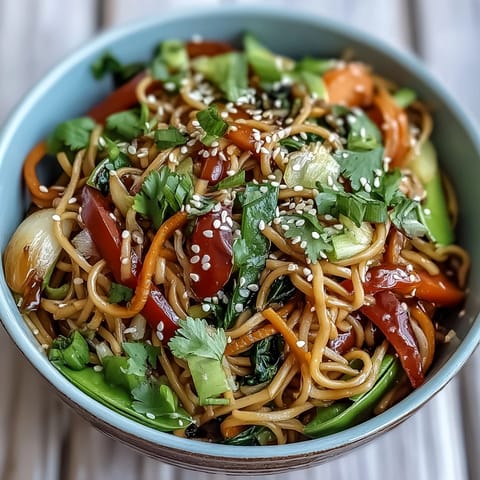 Shirataki noodle bowl with crisp Asian vegetables and a fragrant ginger sauce, ready to serve in a ceramic bowl.