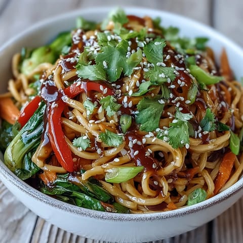 Colorful stir-fried bok choy, bell pepper, and snow peas tossed with shirataki noodles in a glossy ginger sauce.
