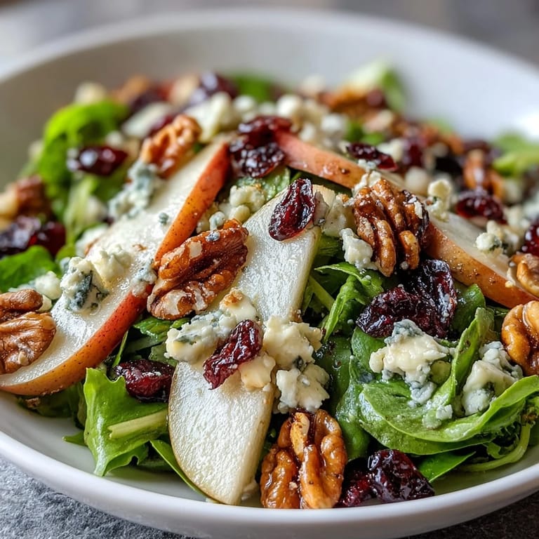 Elegant Pear Gorgonzola Salad, perfect appetizer with honey-balsamic dressing and crunchy nuts.