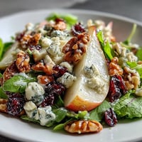 Fresh Pear Gorgonzola Salad with sweet pears, creamy cheese, and toasted walnuts.